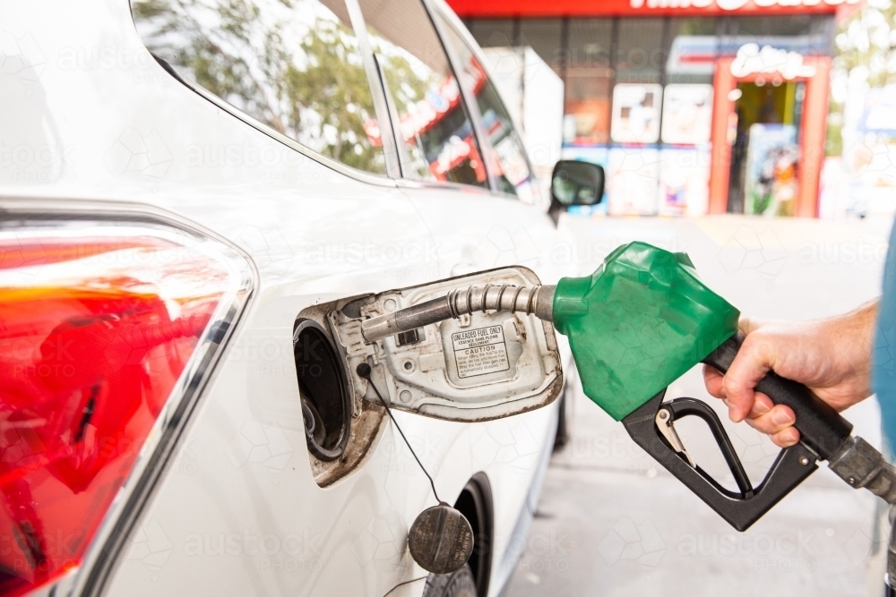 about to put the fuel spout in a car at a petrol station - Australian Stock Image