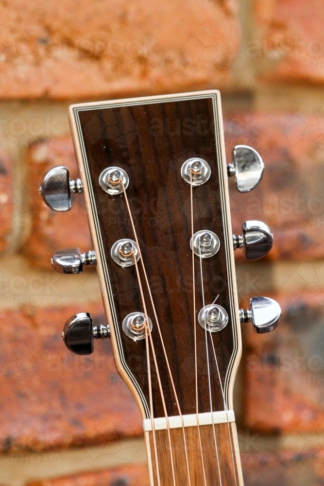 Image of Acoustic guitar headstock showing string tuners. Austockphoto