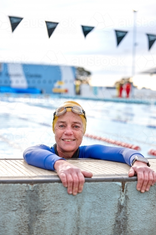 Active senior lady exercising in swimming pool - Australian Stock Image