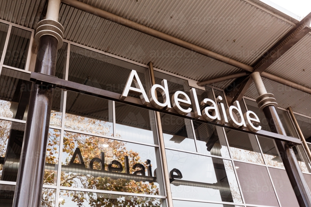 Adelaide text reflected in glass windows with reflection of tree - Australian Stock Image
