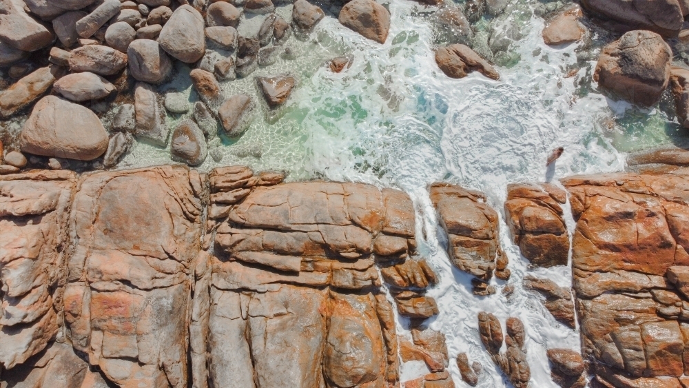 Aerial drone shot of woman in rock pools of Injidup Natural Spa in Yallingup Western Australia - Australian Stock Image