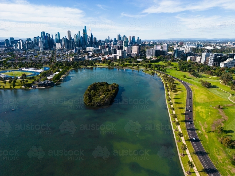 Aerial image above Albert Park Lake looking towards the Melbourne city centre - Australian Stock Image