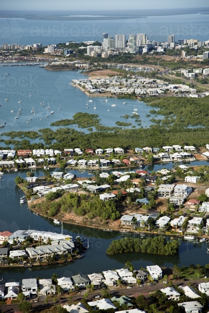 Aerial image of waterfront housing with city and harbour in the background - Australian Stock Image
