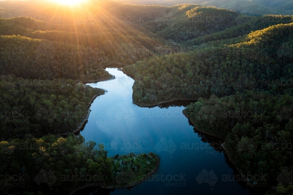 Aerial landscape of a lake surrounded by forest - Australian Stock Image