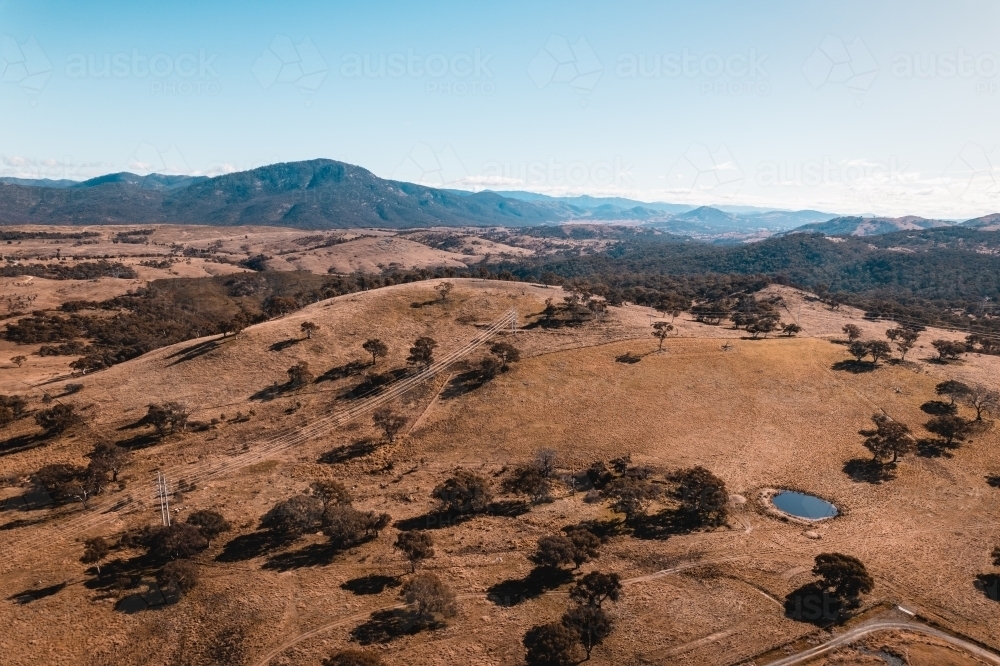 Aerial landscape of rolling countryside and mountains, on the outskirts of Canberra ACT. - Australian Stock Image