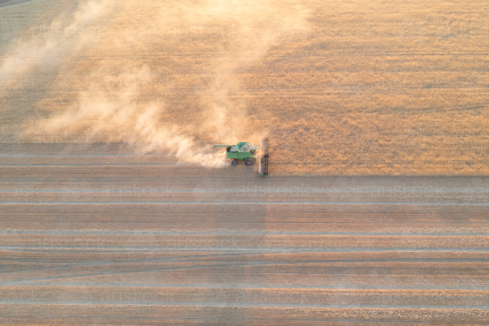 Aerial of harvester at dusk in the Wheatbelt - Australian Stock Image