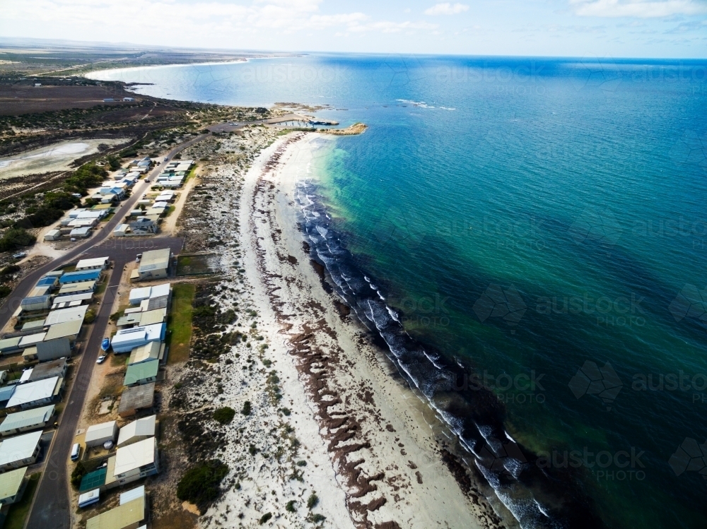 Aerial of seaside shacks and beach - Australian Stock Image