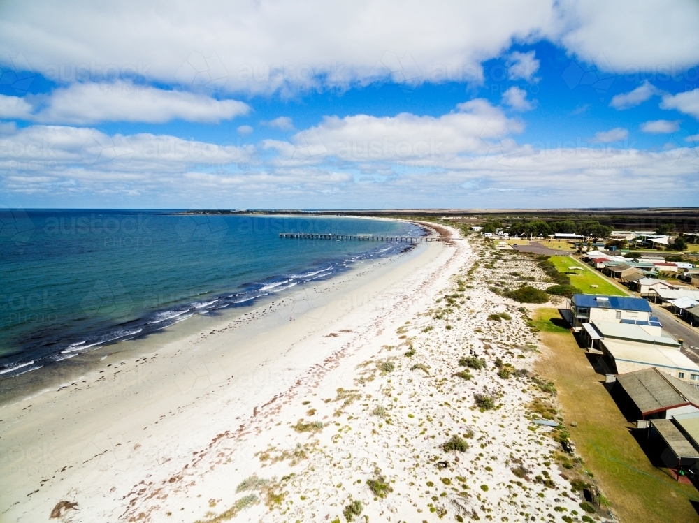 Aerial of seaside shacks and beach - Australian Stock Image