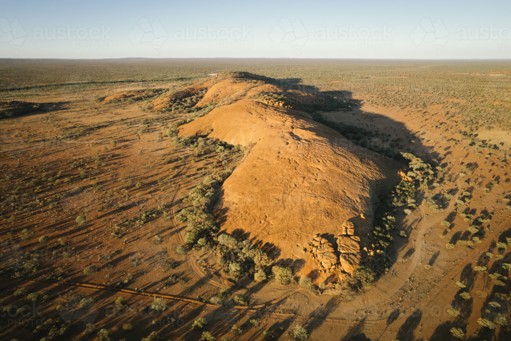 Aerial of Walgahna Walga Rock at sunset near Cue Western Australia - Australian Stock Image