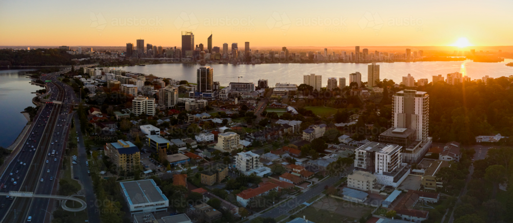 Aerial panorama of South Perth and Perth City skyline as the sun rises on the horizon - Australian Stock Image