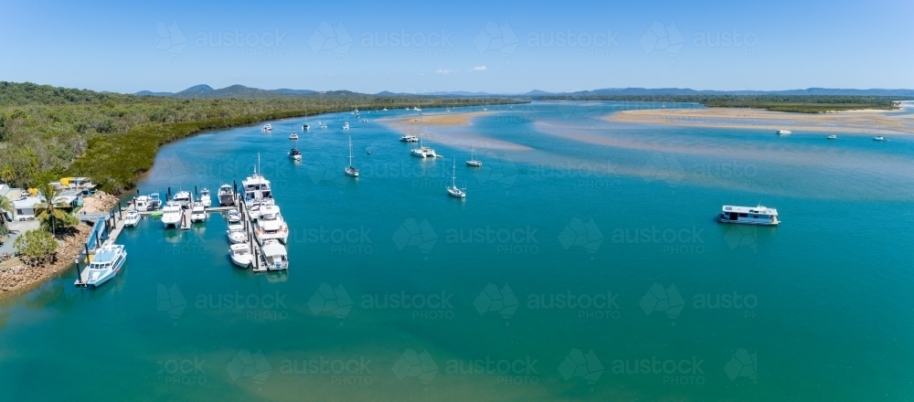 Aerial panorama of the 1770 Marina and yachts anchored in the estuary, Town of 1770, QLD. - Australian Stock Image