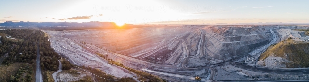 Aerial panoramic view of open cut coal mine in Bulga area of the Hunter Valley at dusk - Australian Stock Image