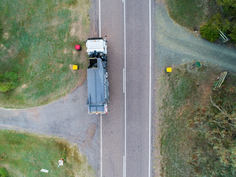 Aerial photo of garbage truck emptying bins in rural location - Australian Stock Image