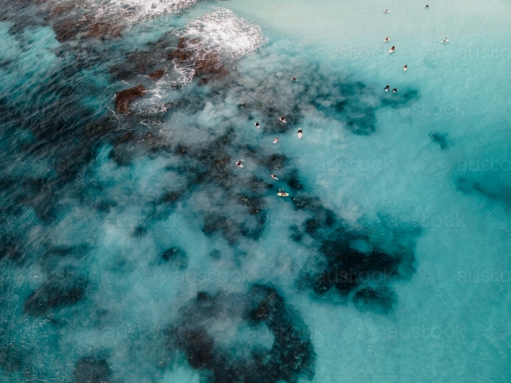 Aerial shot of people swimming in ocean water - Australian Stock Image