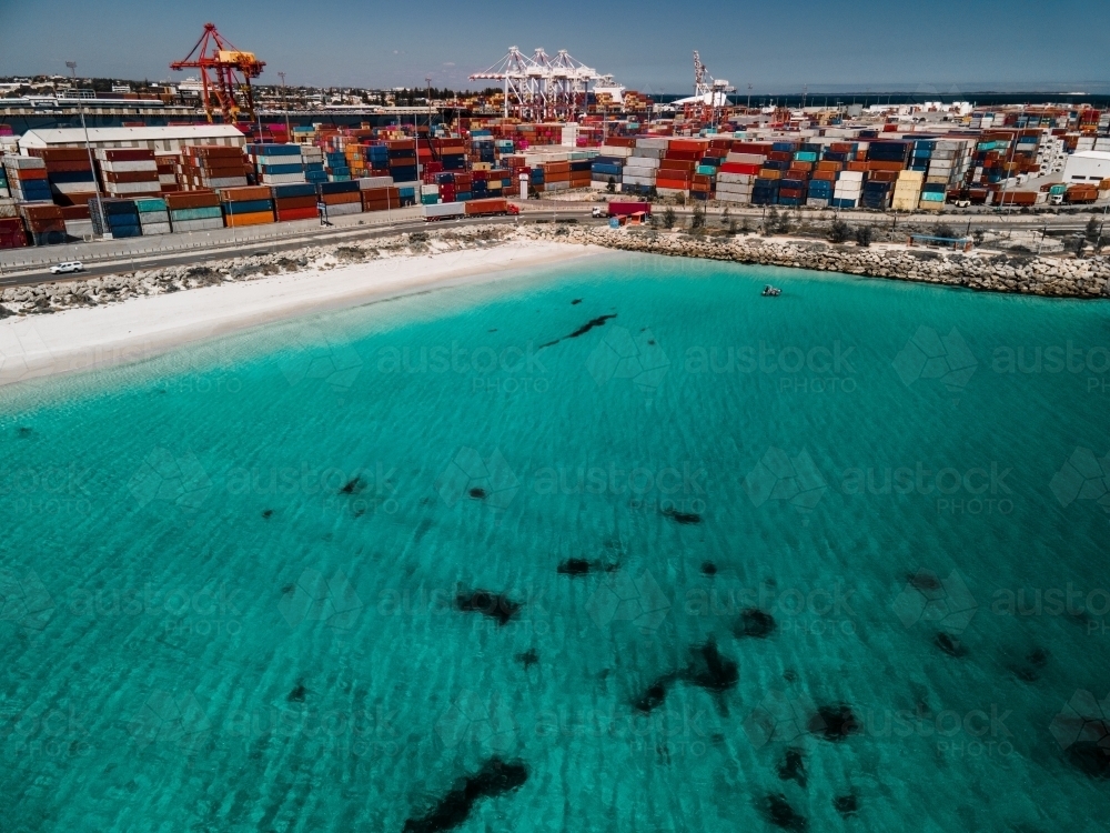 Aerial shot over the water to Fremantle Port and shipping containers - Australian Stock Image