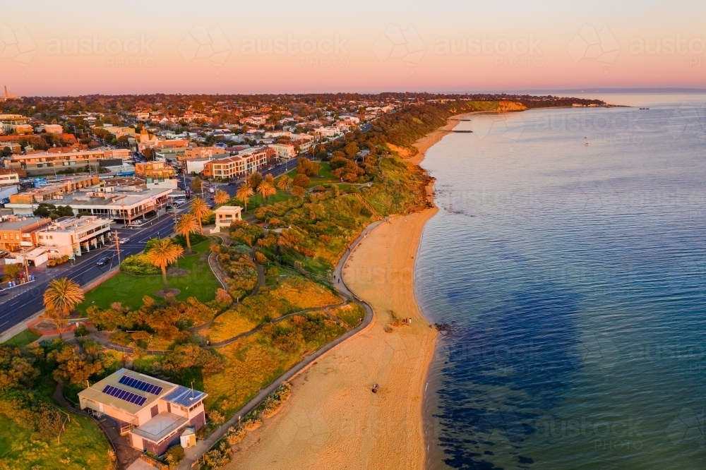 Aerial view a bay side beach with a surf life saving club house - Australian Stock Image