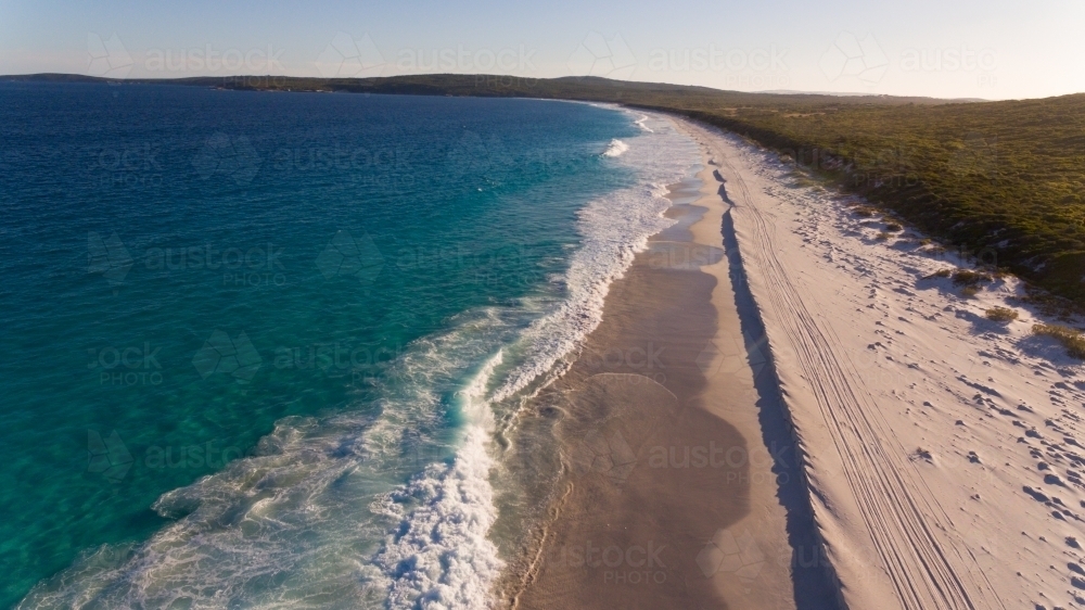 Aerial view along expansive sandy beach - Australian Stock Image