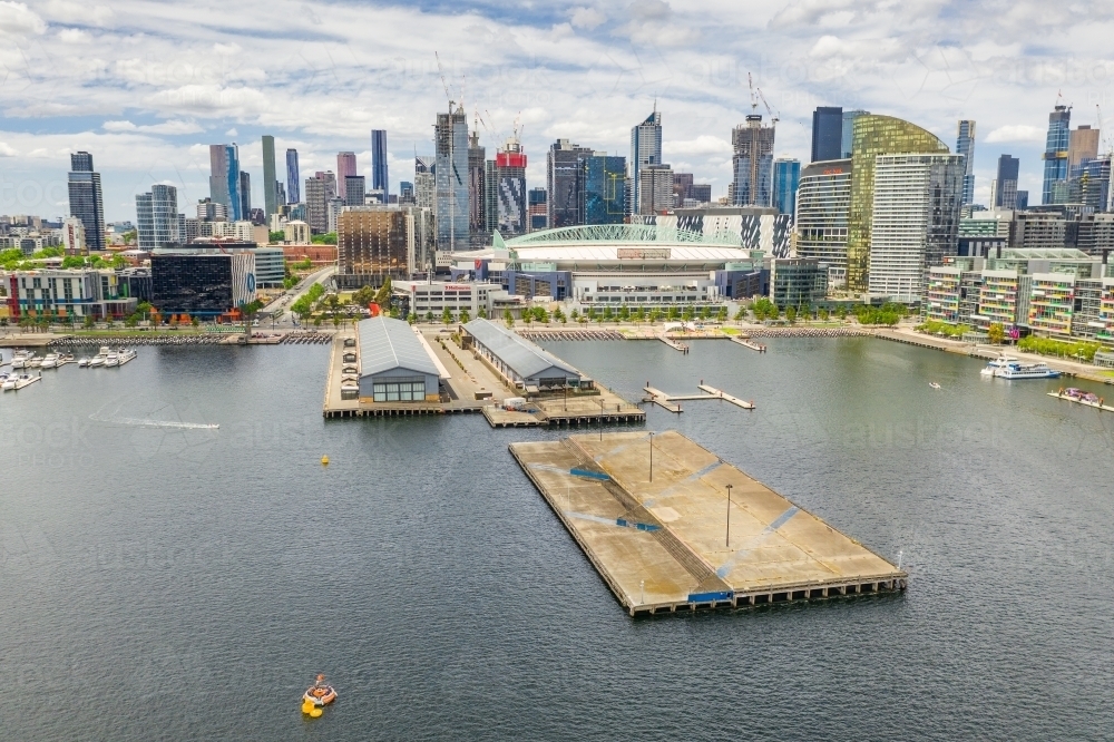 Aerial view Docklands Central Pier in front of the Melbourne CBD skyline - Australian Stock Image