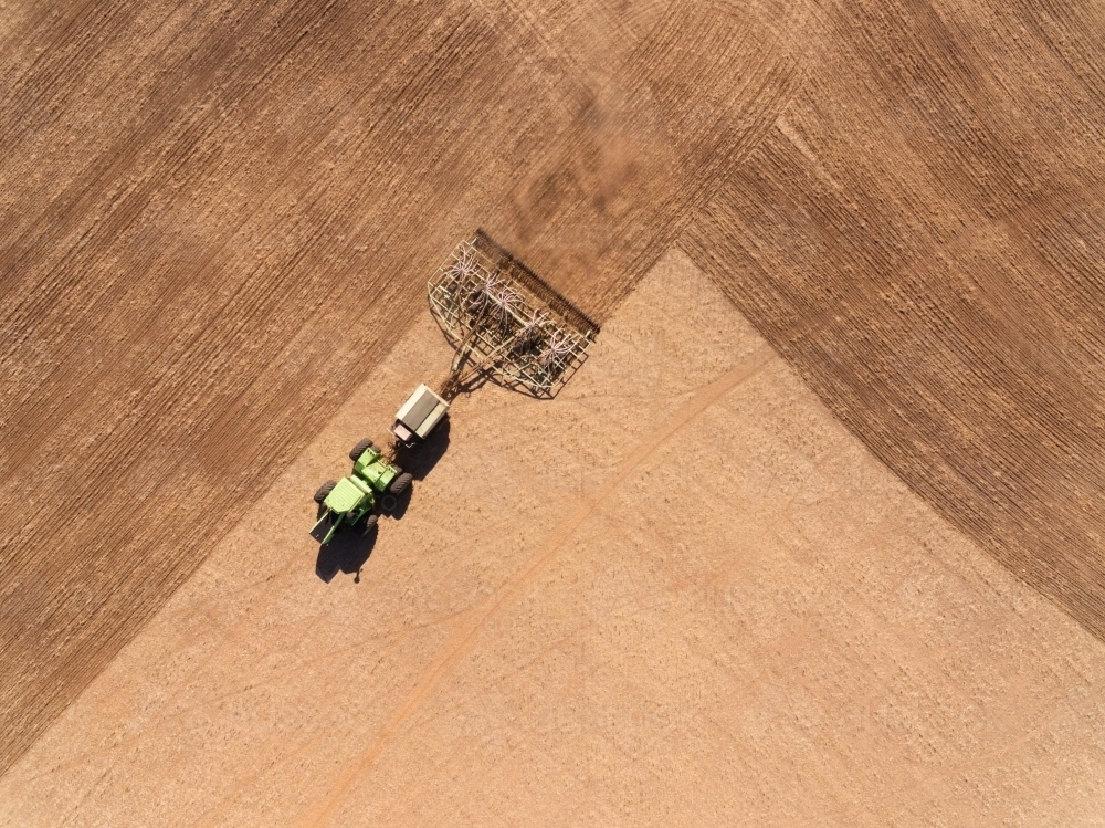 Aerial view looking down on farm machinery sowing crop - Australian Stock Image