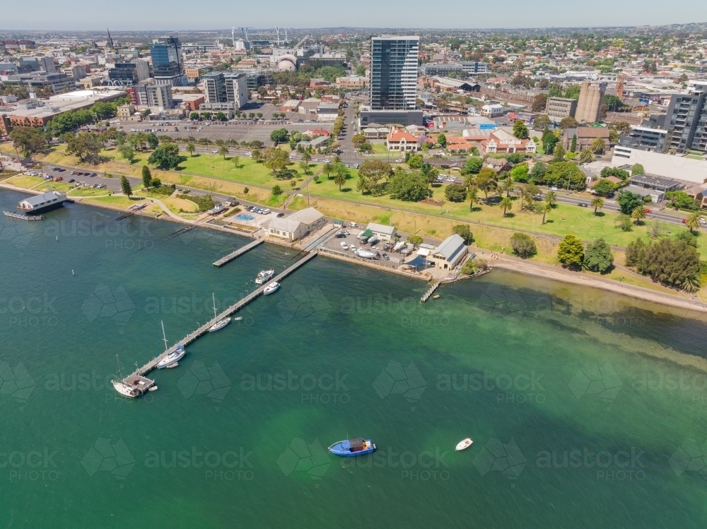 Aerial view of a bay side waterfront precinct with with a long narrow jetty - Australian Stock Image