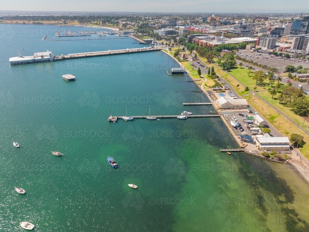 Aerial view of a bay side waterfront precinct with with long narrow jetty - Australian Stock Image