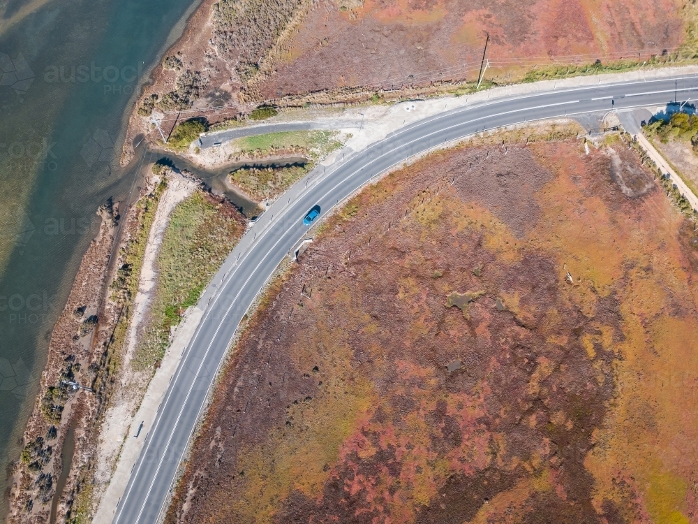 Aerial view of a bend in a road along side a river - Australian Stock Image