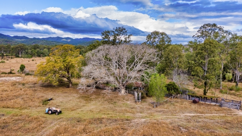 Aerial view of a big field with a tractor driving by - Australian Stock Image