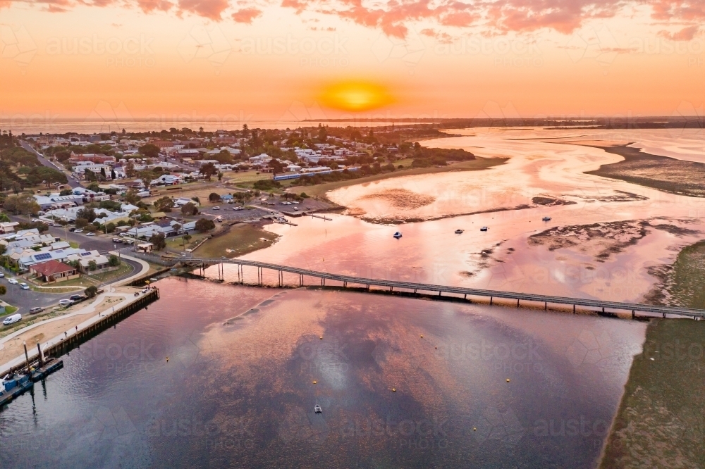 Aerial view of a coastal marina under a golden sunset. - Australian Stock Image