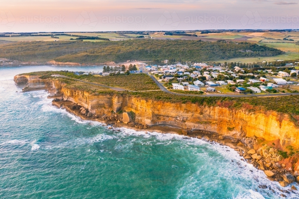 Aerial view of a coastal town on sea cliffs above a rugged coastline - Australian Stock Image