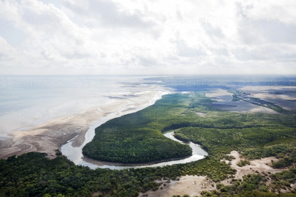 Aerial view of a curving river system running into the ocean - Australian Stock Image