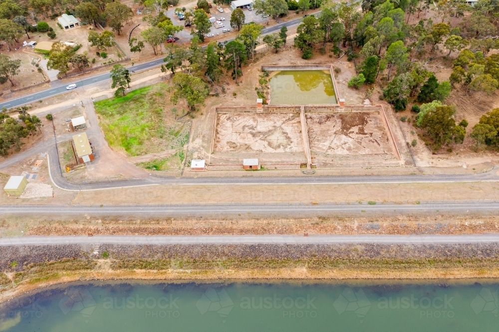 Aerial view of a dam wall and settling ponds - Australian Stock Image