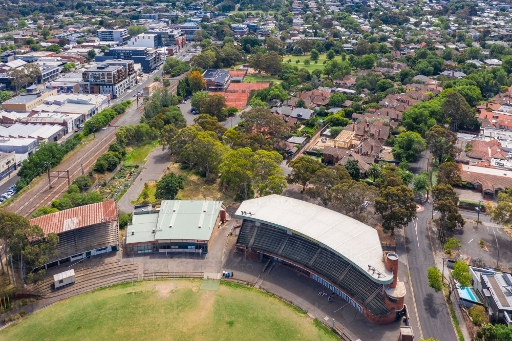 Aerial view of a football oval and grandstands and surrounding suburbs - Australian Stock Image