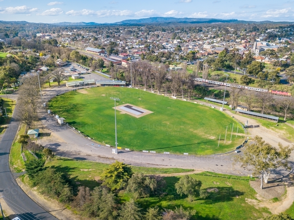 Aerial view of a football oval next to a railway line - Australian Stock Image