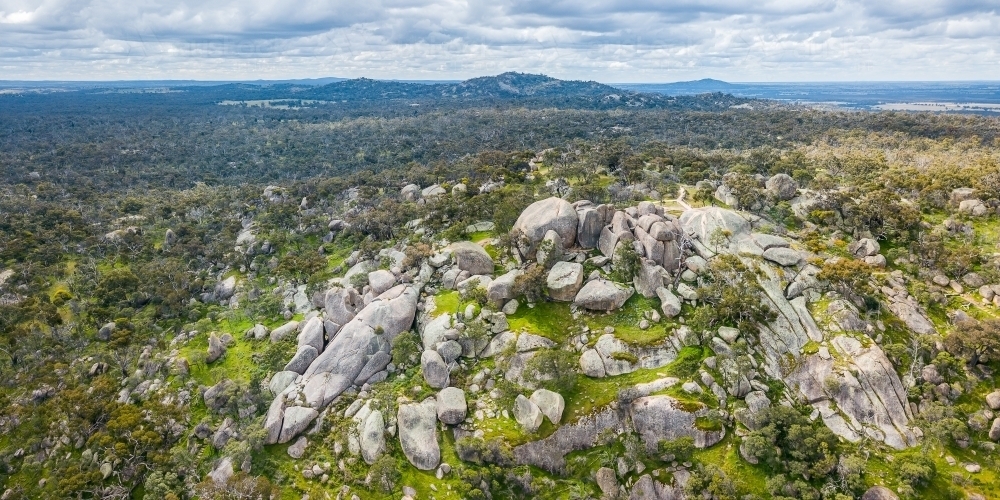 Aerial view of a hilltop covered in large granite boulders - Australian Stock Image