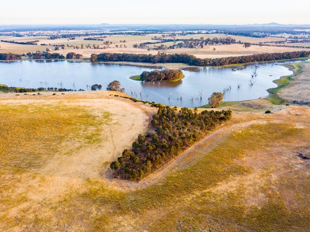 Aerial view of a lake surrounded by dry farmland - Australian Stock Image