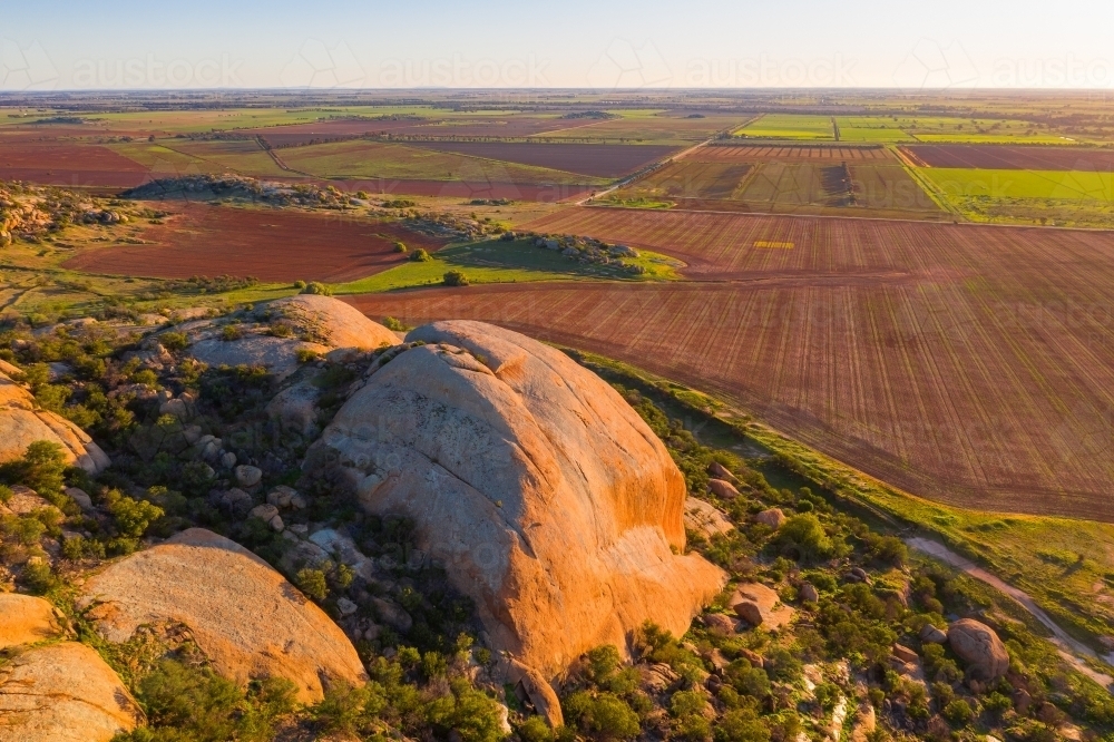 Aerial view of a large granite mountain in late evening sunshine - Australian Stock Image