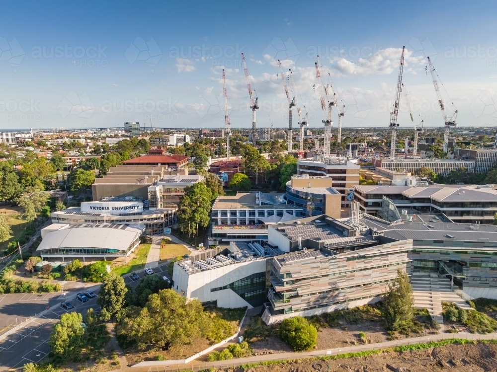 Aerial view of a large University campus with large construction cranes above - Australian Stock Image