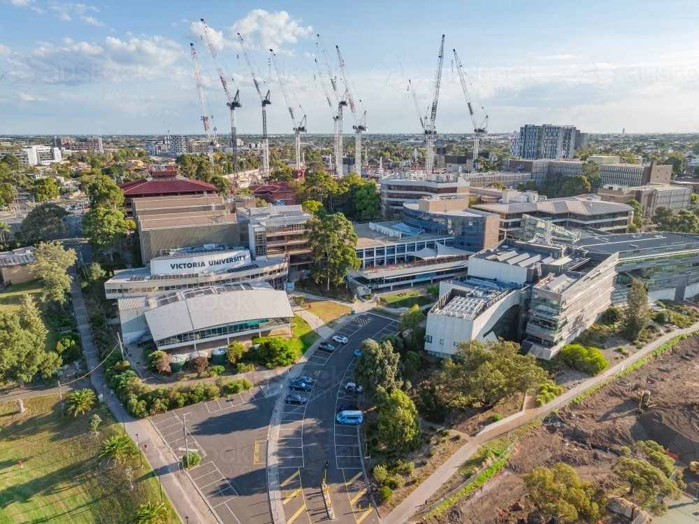 Aerial view of a large University campus with large construction cranes above - Australian Stock Image