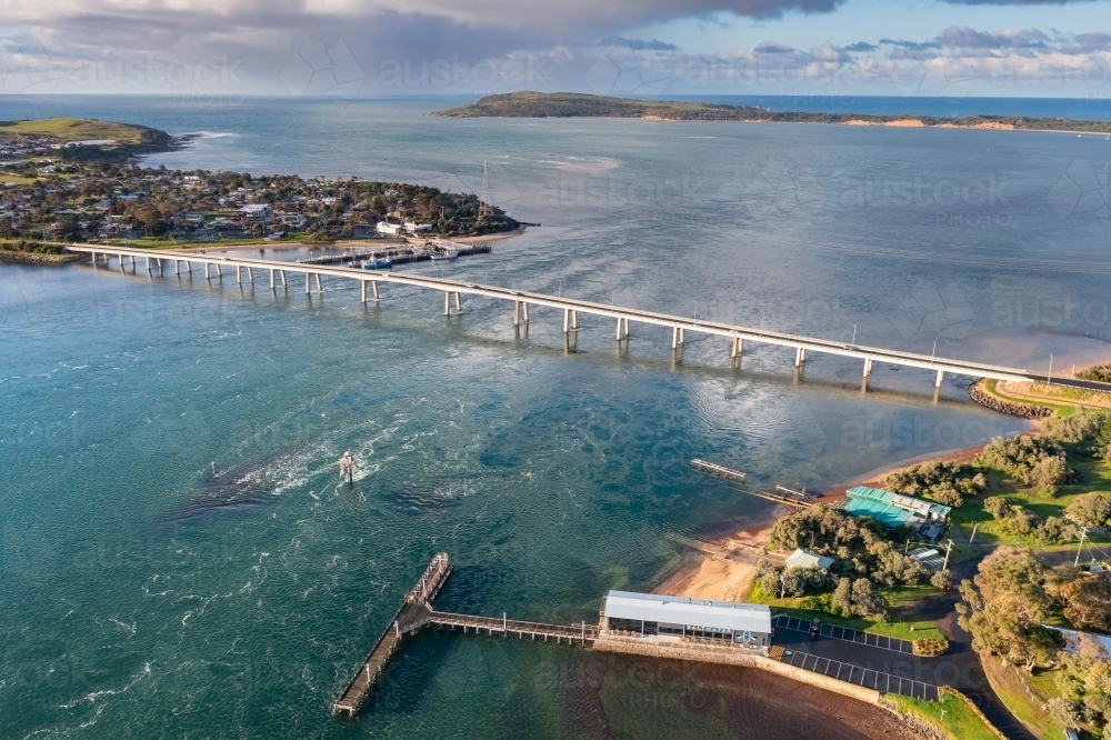 Aerial view of a narrow bridge linking the mainland to a coastal island - Australian Stock Image