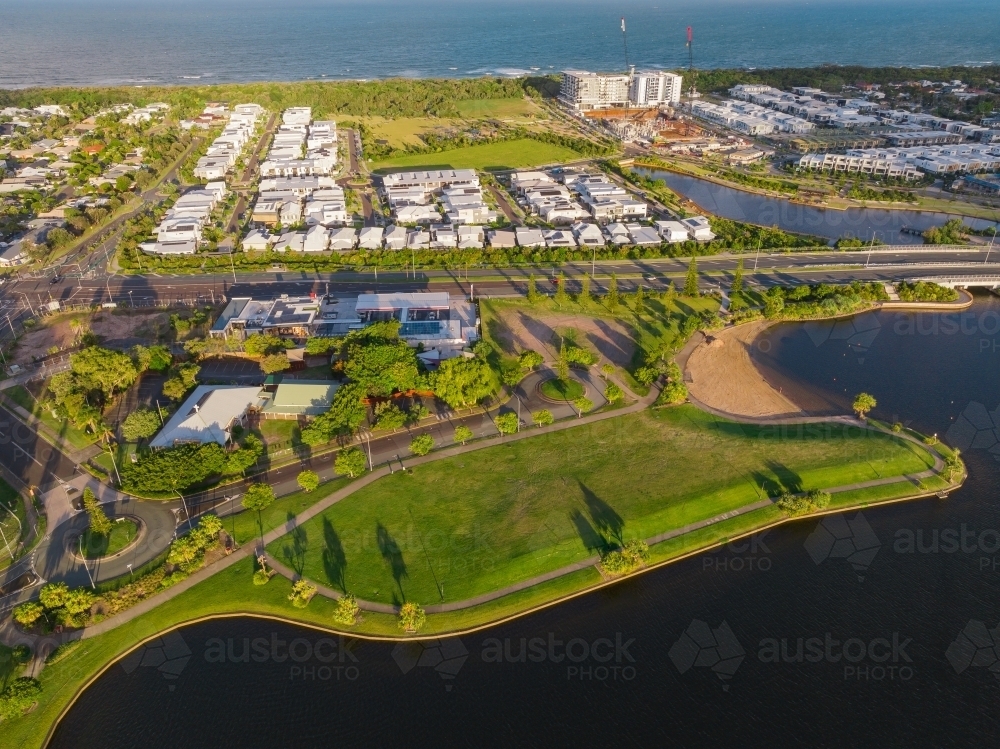 Aerial view of a parkland reserve and waterfront property around coastal canals - Australian Stock Image