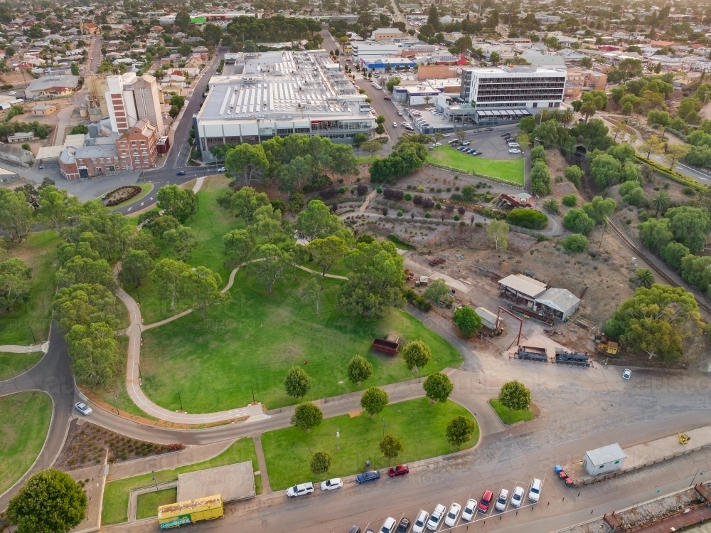 Aerial view of a parkland reserve with city buildings behind - Australian Stock Image