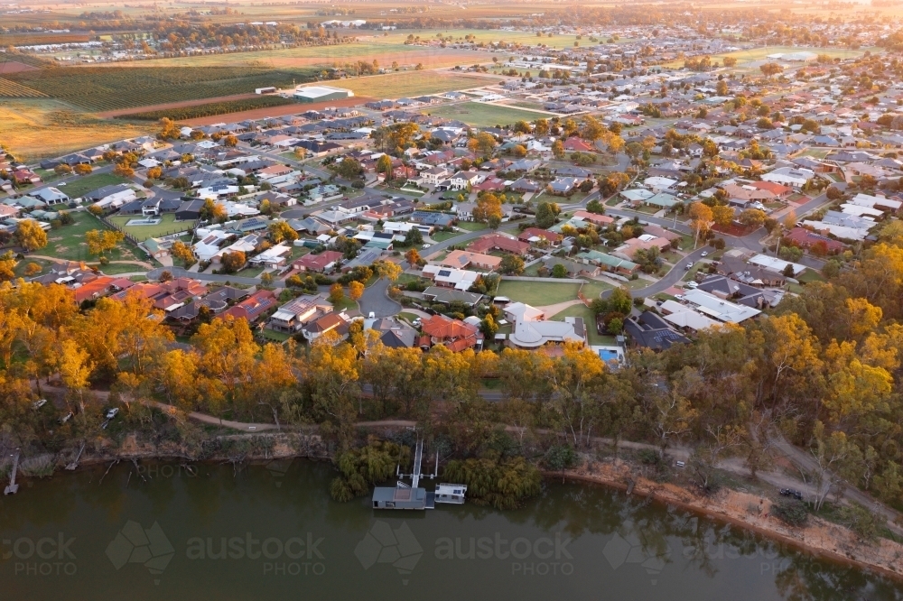 Aerial view of a regional town spread out along the side of a river - Australian Stock Image