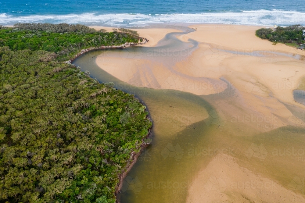 Aerial view of a river winding its way around sand bars and out to sea - Australian Stock Image