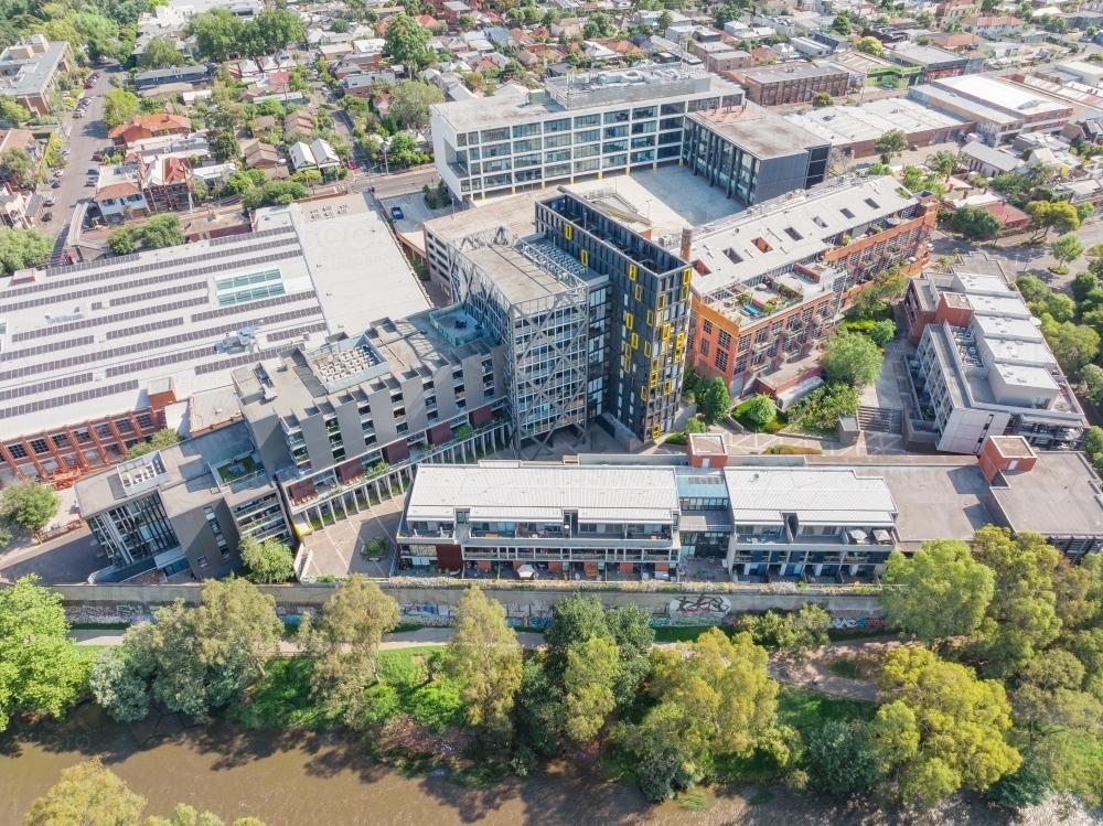 Aerial view of a river with city buildings along side - Australian Stock Image