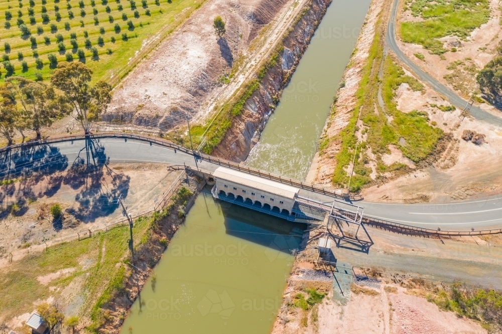 Aerial view of a road crossing over flood gates on a water channel - Australian Stock Image