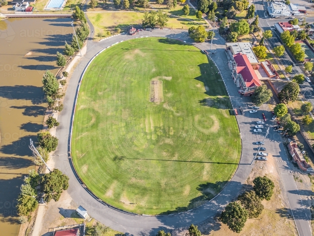 Aerial view of a road surrounding a football oval and grandstand - Australian Stock Image