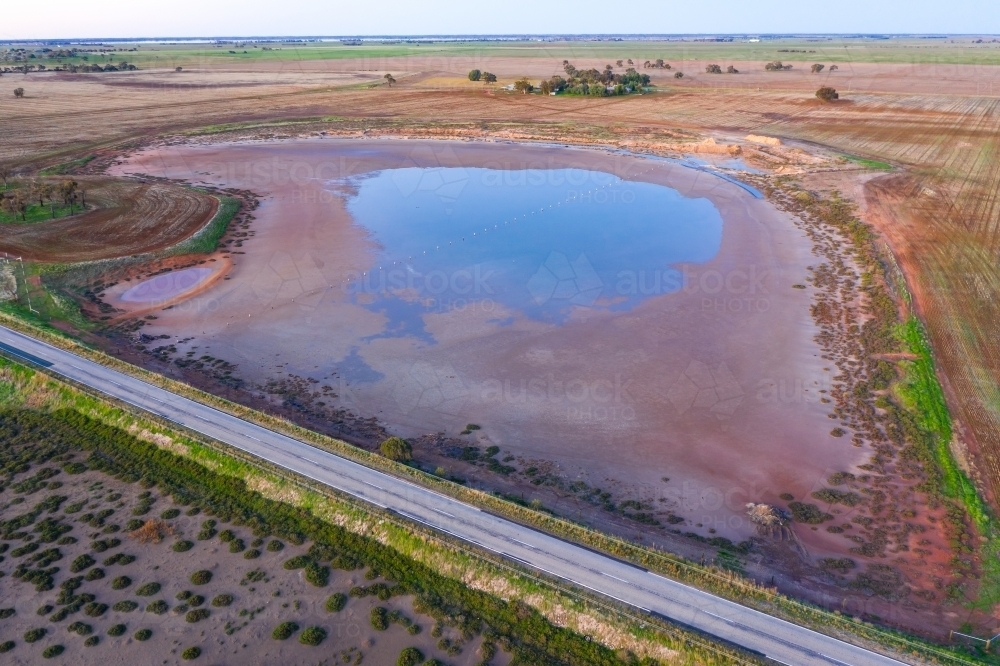 Aerial view of a roadside salt lake with colourful salt crusted edges - Australian Stock Image