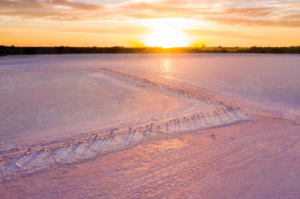 Aerial view of a sunset over a pink salt lake - Australian Stock Image