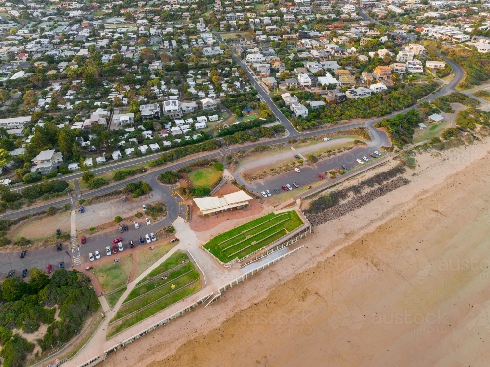 Aerial view of a Surf Life Saving Club and coastal town above a sandy beach - Australian Stock Image