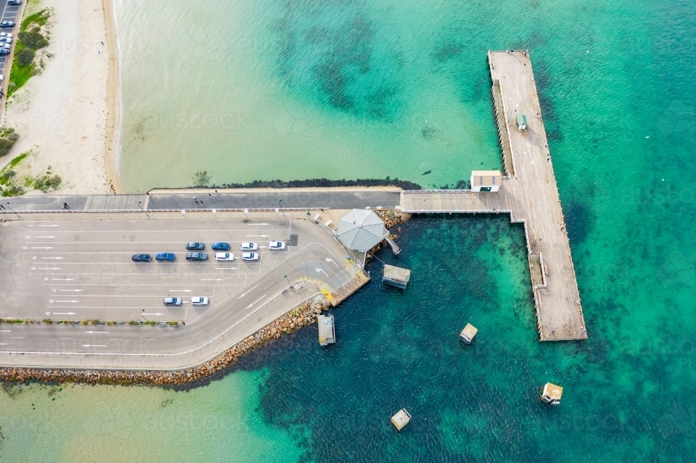 Aerial view of a T shaped jetty out over the ocean - Australian Stock Image